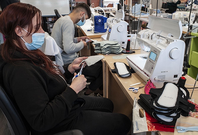 Atelier couture de kits de protection périodique - Samiullah, jeune Afghan réfugié, dessine les futurs kits d’hygiène. Elise, en insertion au sein du Kiosque à couture – l’une des nombreuses activités de la structure d’insertion Ozange.
